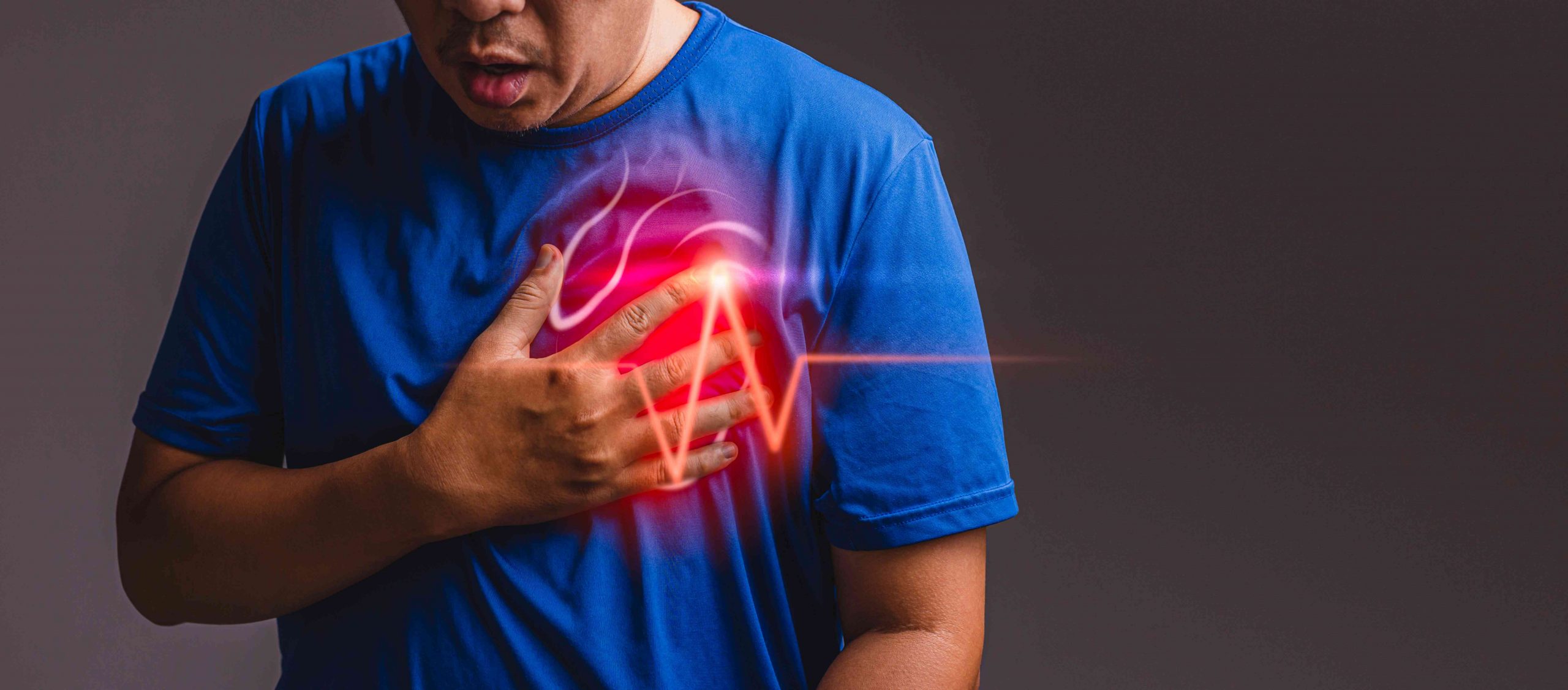 a person holding his chest with a heart attack