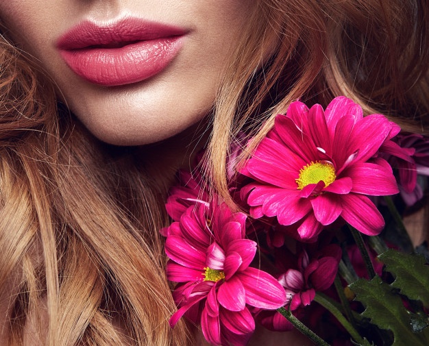 women holding a flower  in closeup