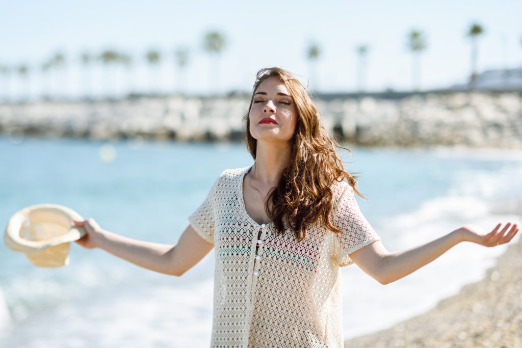 woman out in the sun exposing face to sun