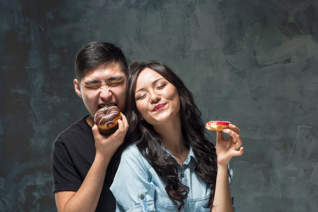 A couple enjoying their delicious snack.