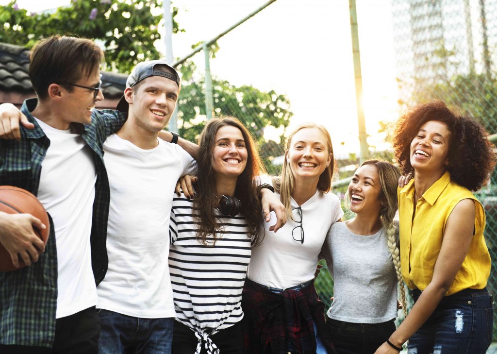 group of teenage boys and girls standing 