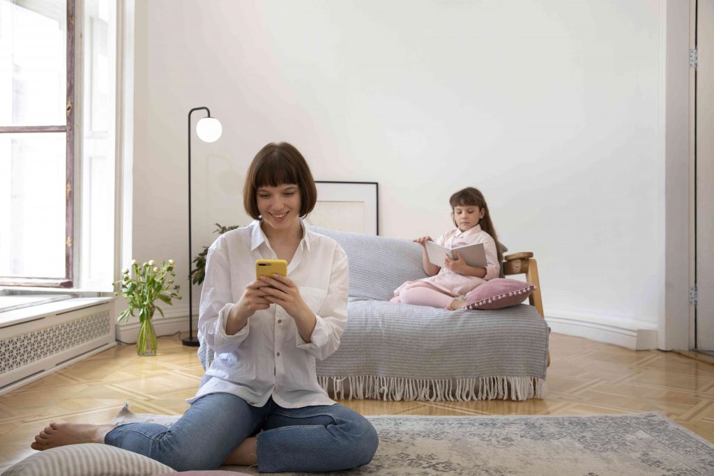 a person sitting on a couch looking at a phone