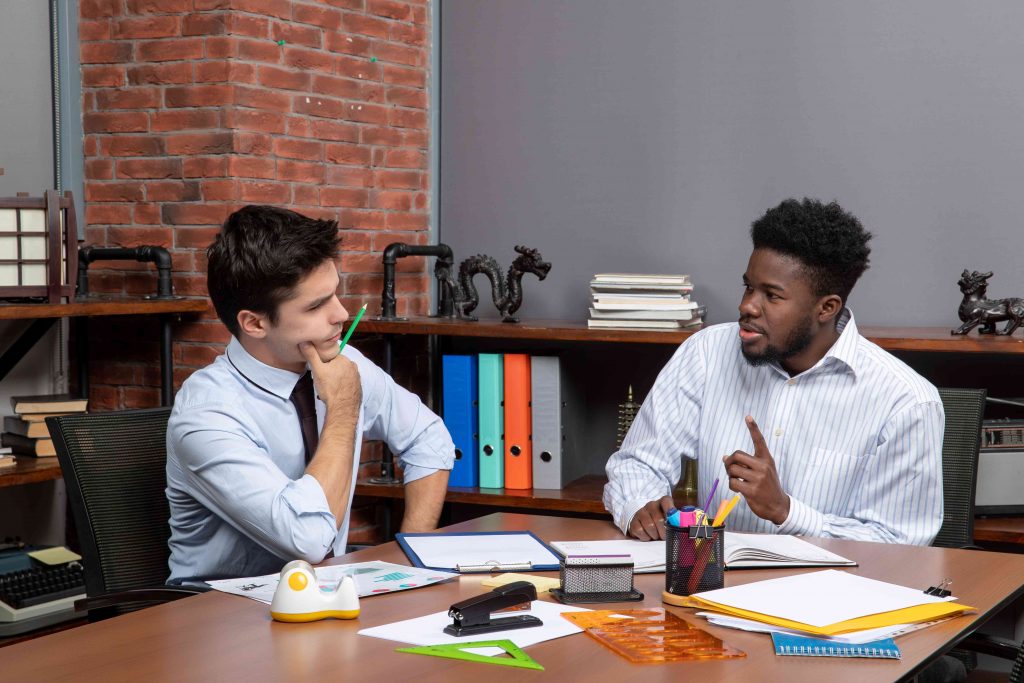 two men discussing  on the table 