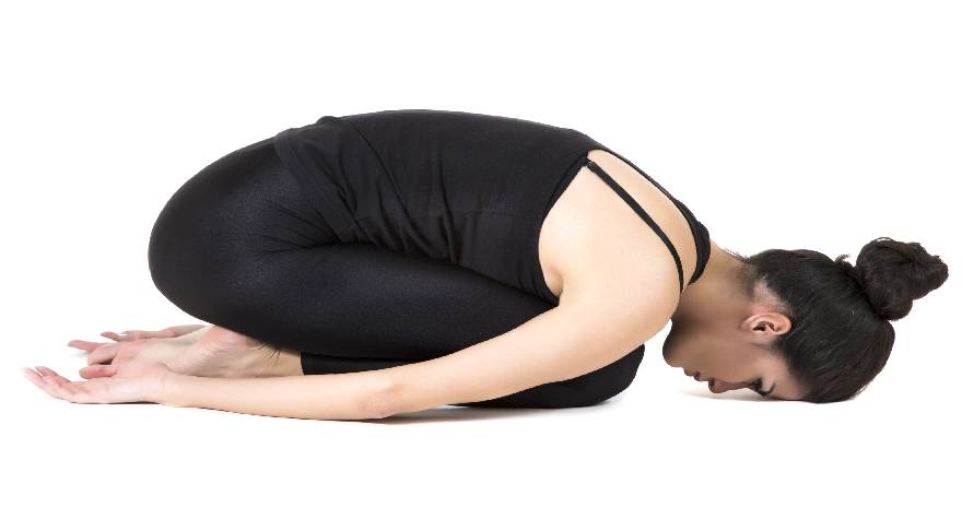 woman doing child pose yoga to relieve d\stress due to dyslexia