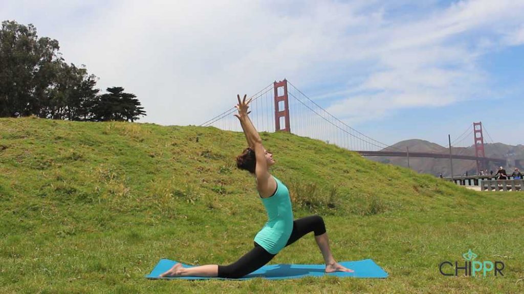 A woman practising yoga across the golden gate bridge.