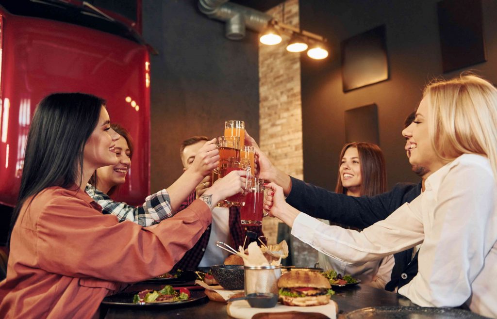 a group of girls having beer after work