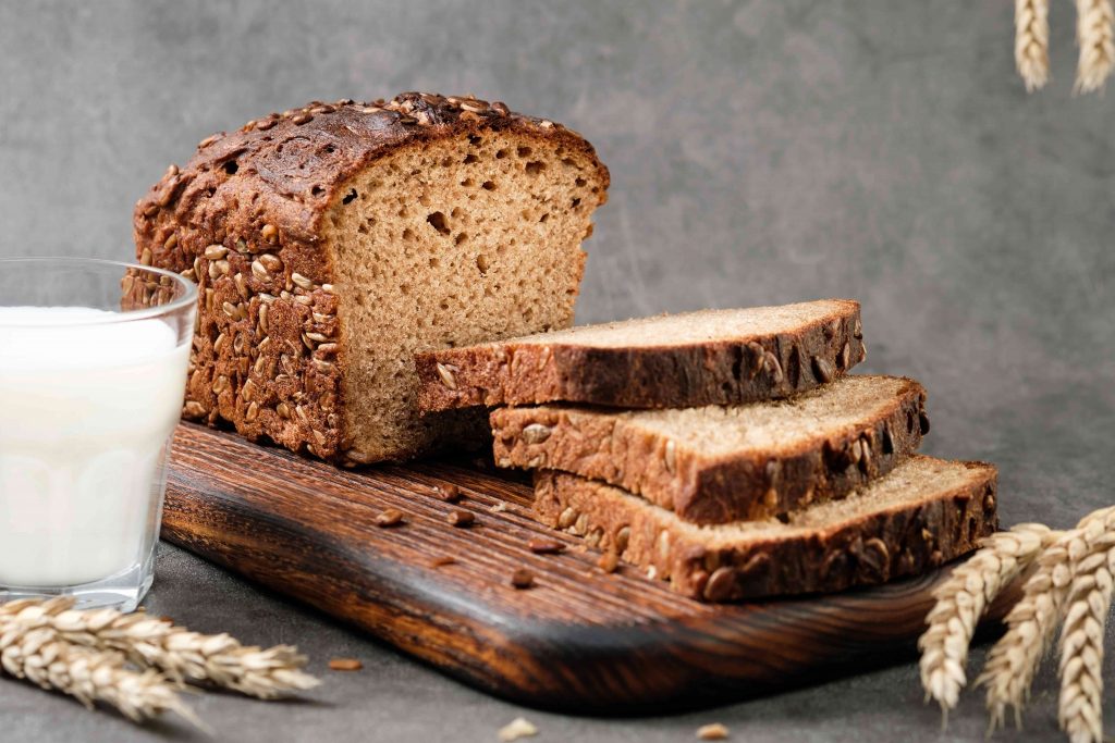 pumpernickel rye bread loaves on a wooden plate