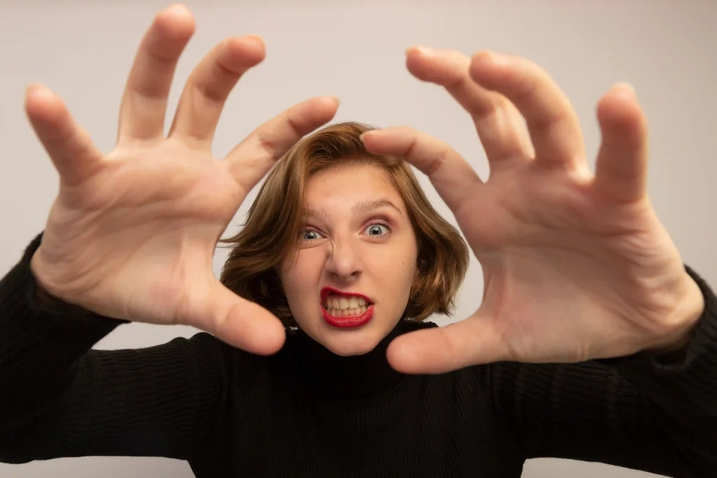 woman with tiger-paws gesture as a symbol of a woman trying to manipulate people