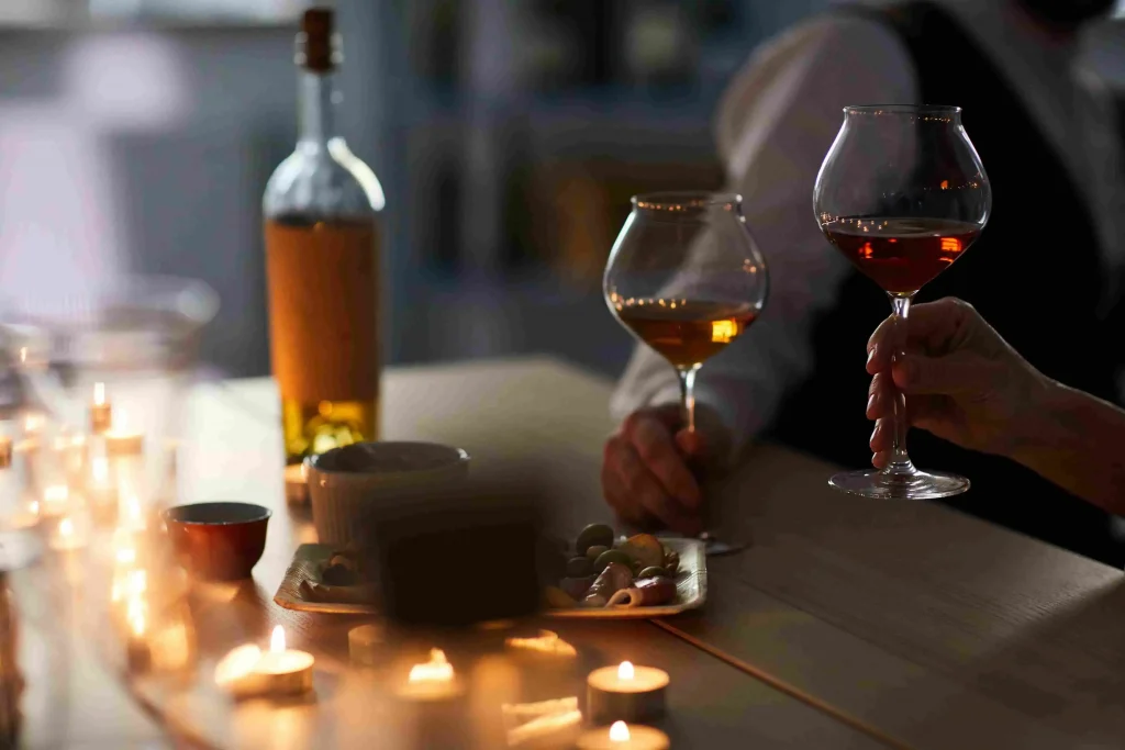 man and woman intimate moments with a glass of wine in both hands